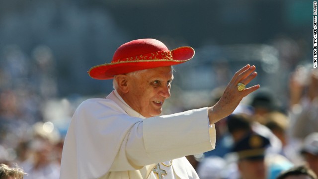 Pope Benedict XVI wearing a red hat blesses the faithfull during his weekly audience in Saint Peter&#39;s Square at the Vatican, 06 Septembre 2006. The Italian name of the pope&#39;s Roman hat is &quot;saturno,&quot; presumably because it looks like half of the planet Saturn. 
