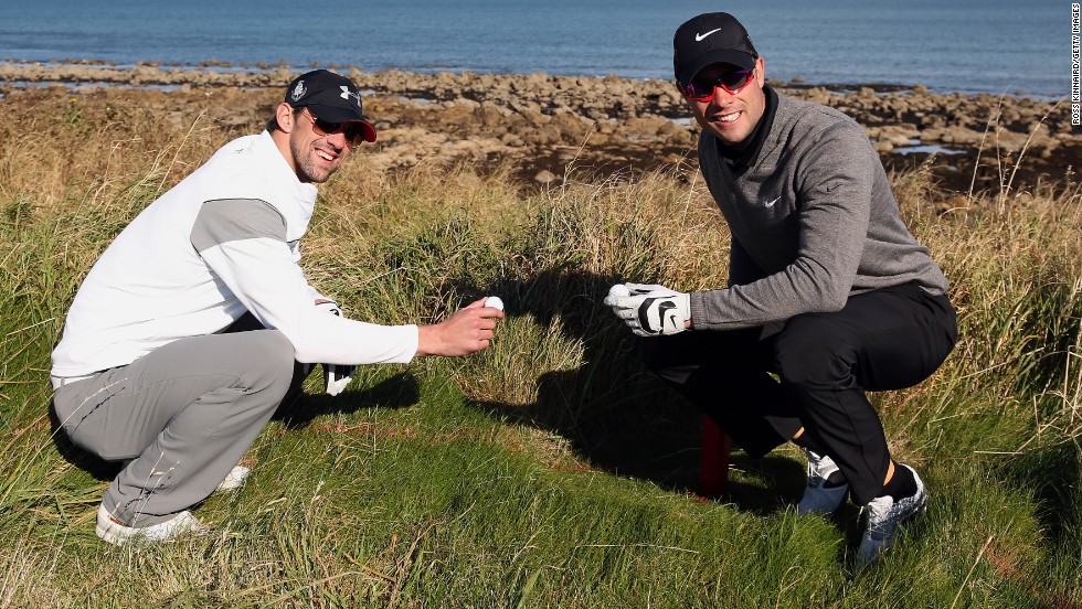 Phelps poses with Paralympic running champion Oscar Pistorius after they both lose their ball during the Alfred Dunhill Links Championship pro-am at Kingsbarns in Scotland in October 2012.