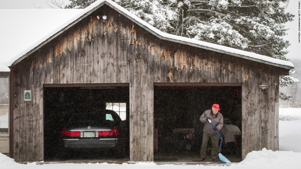 World War II veteran Sam Melnik, 90, shovels snow from his driveway on Tuesday, March 19, in Deerfield, Massachusetts.