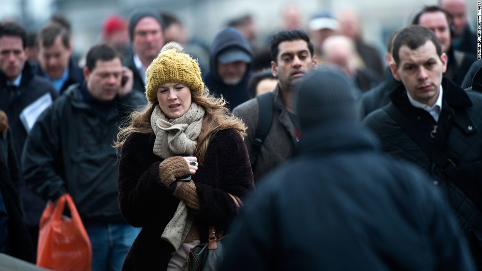 Cold weather keeps Britons bundled up as they cross the London Bridge on March 22. 