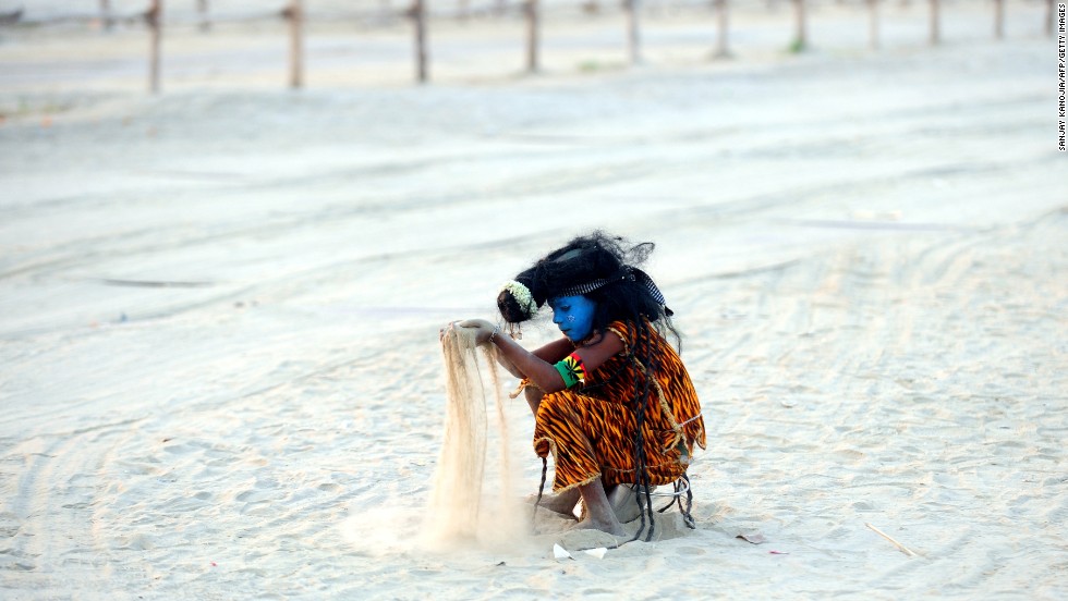 An Indian child dressed as the Hindu god Shiva plays with sand on the banks of the Sangam in Allahabad on March 5. 