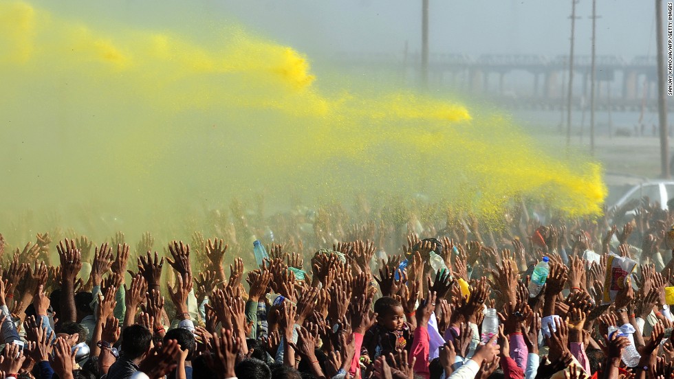 Colored powder billows over the crowd during the Kumbh Mela festival in Allahabad, India, on March 9, 2013, during which pilgrims symbolically wash off their sins in a two-month-long festival.