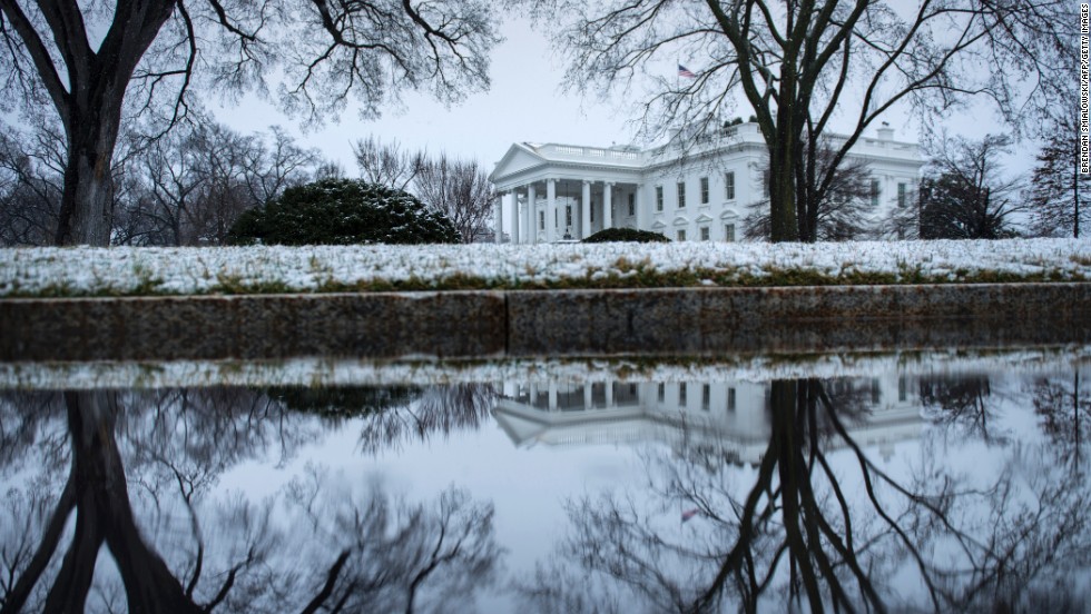 Snow covers the shrubbery around the White House on Monday, March 25.