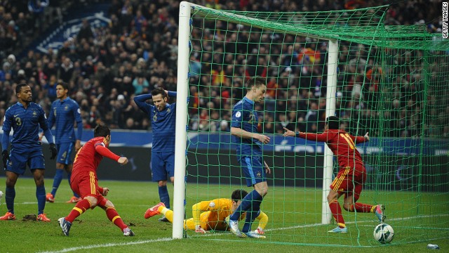 Pedro rushes out of the goalmouth after converting Nacho Monreal&#39;s cross to give the world champions a key win in Paris. 