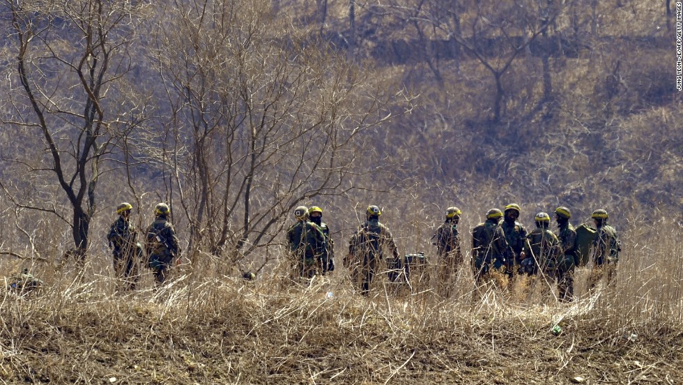 South Korean soldiers gather at the foot of a mountain near a military drill field in the border city of Paju on Wednesday, March 27. 