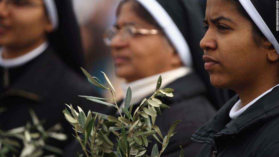 Nuns hold olive leaves on March 24.