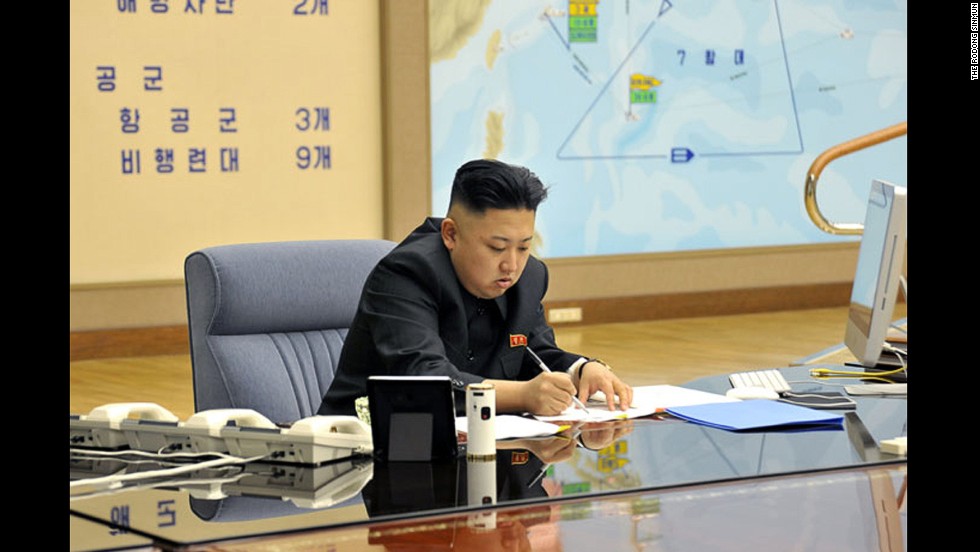 Kim works during a briefing in this undated photo.