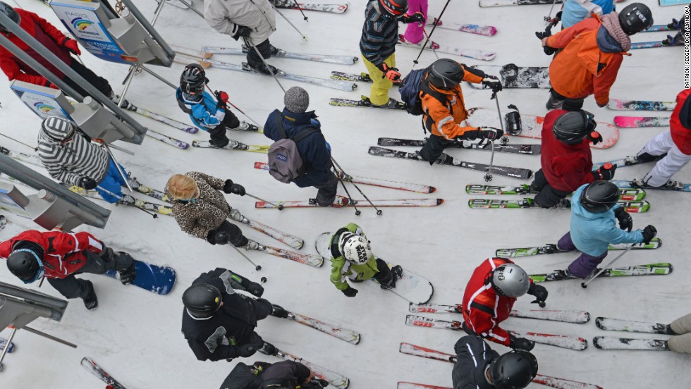 Snowboarders and skiers wait to take a ski lift at Feldberg Mountain in Schwarzwald, Germany, on Friday, March 29.