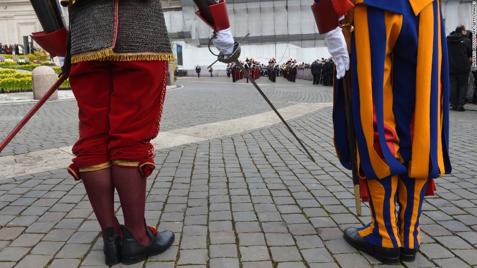 Swiss guards stand in St. Peter&#39;s Square before the Easter celebrations on Sunday.