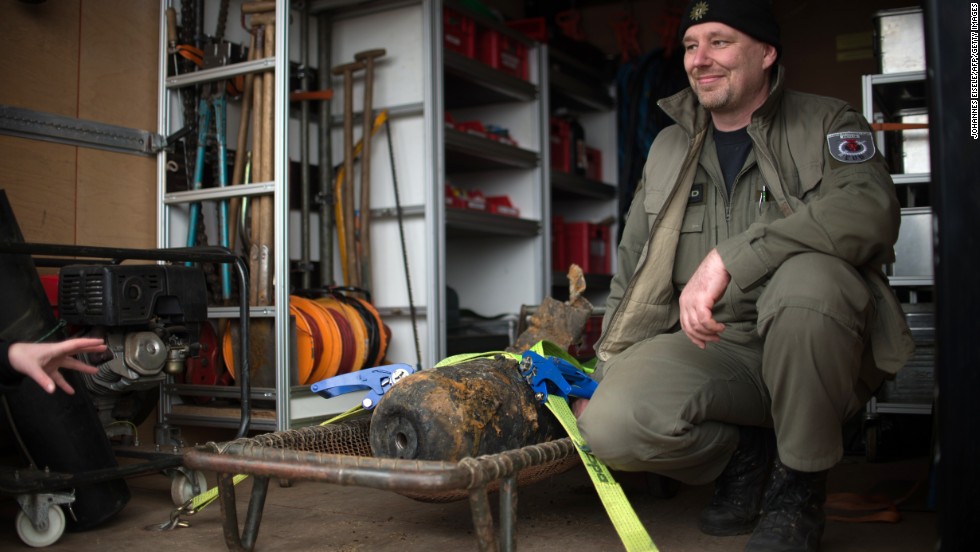 Joerg Neumann of the bomb disposal team poses next to the defused bomb.