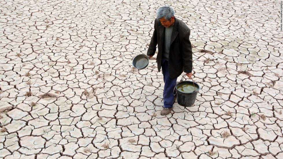 Villager Fu Xianxing, 70, walks on a dried-up field Tuesday, April 2, in Suining, China. A severe drought has caused a shortage of drinking water in the area in southwest China&#39;s Sichuan province.