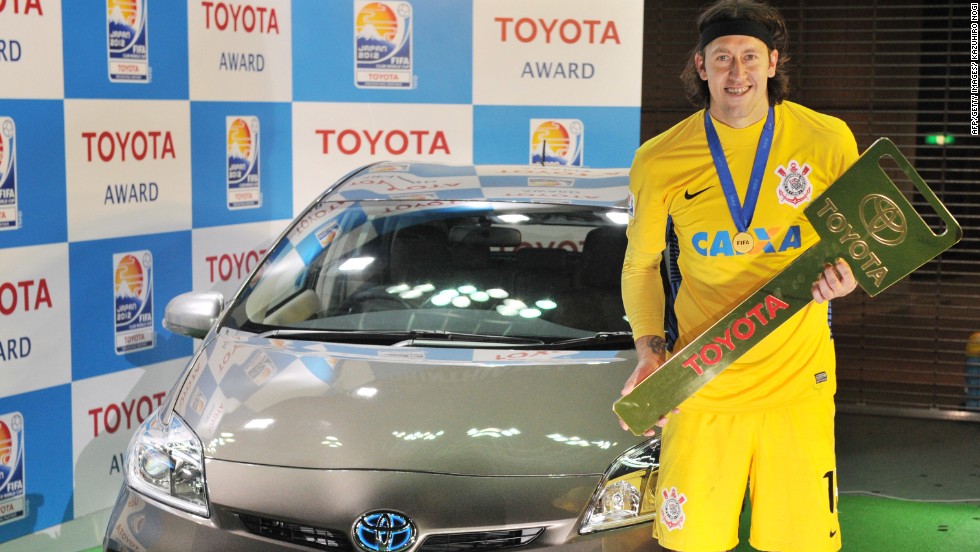 Corinthians goalkeeper Cassio poses besides a Toyota Prius vehicle after he won the Most Valuable Player (MVP) prize during the awards ceremony of the Football Club World Cup in Yokohama. 