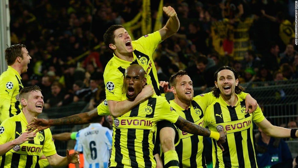 Dortmund&#39;s players celebrate their famous 3-2 victory over Malaga and will now look forward to the semifinals where it could be joined by fellow German club Bayern Munich.