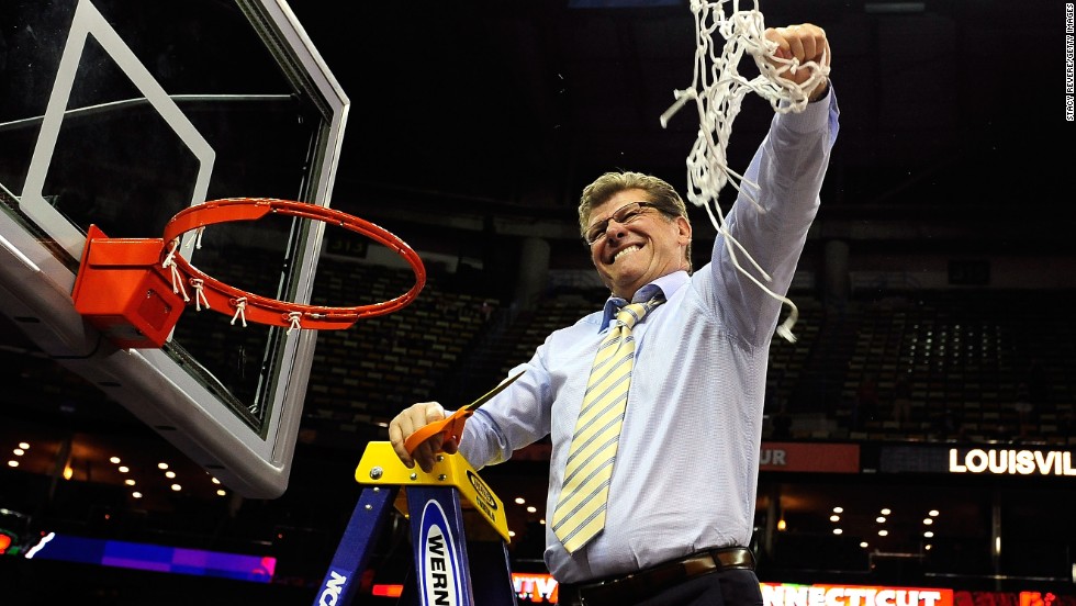 UCONN head coach Geno Auriemma cuts down the net after defeating the Louisville Cardinals on April 9.