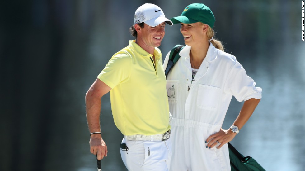 Rory McIlroy of Northern Ireland stands with his caddie (and professional tennis player) Caroline Wozniacki during the Par 3 Contest before the start of the 2013 Masters Tournament at Augusta National Golf Club in Georgia on Wednesday, April 10.