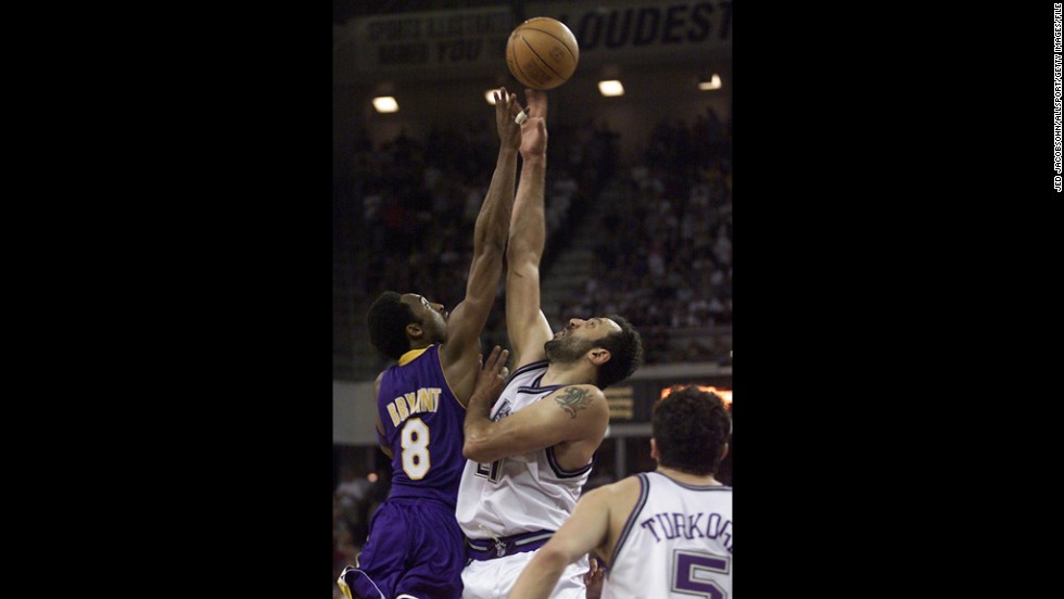 Vlade Divac, No. 21 of the Sacramento Kings, jumps for the ball against Bryant during game four of the Western Conference Semifinals at Arco Arena on May 13, 2001, in Sacramento, California.
