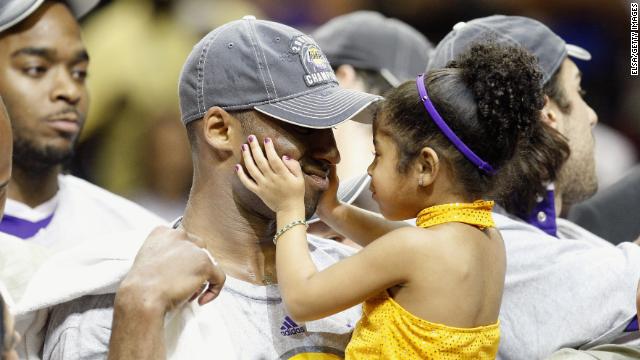 Kobe Bryant holds his daughter, Gianna, after the Lakers defeated the Orlando Magic in Game Five of the 2009 NBA Finals on June 14, 2009, at Amway Arena in Orlando, Florida.