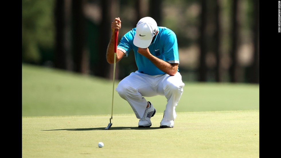 Charl Schwartzel of South Africa reacts after missing a birdie putt on the eighth hole.