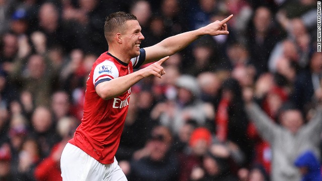 Lukas Podolski celebrates scoring Arsenal&#39;s third goal in the 3-1 over Norwich at the Emirates Stadium.