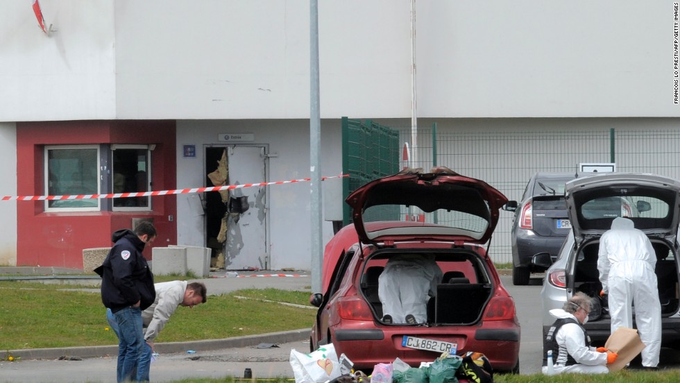 Forensics experts work near a door destroyed by Faid&#39;s explosives in 2013.