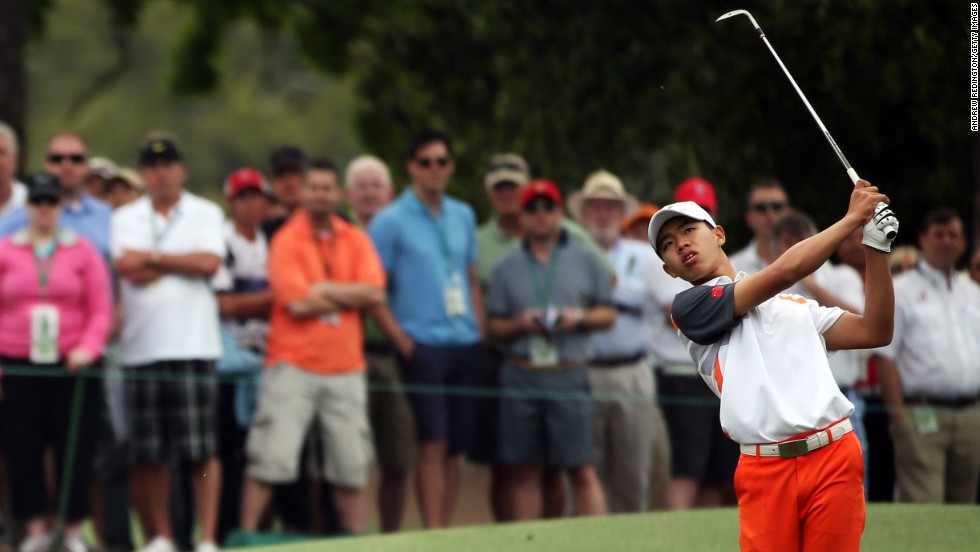 Guan Tianlang of China hits his third shot on the eighth hole.