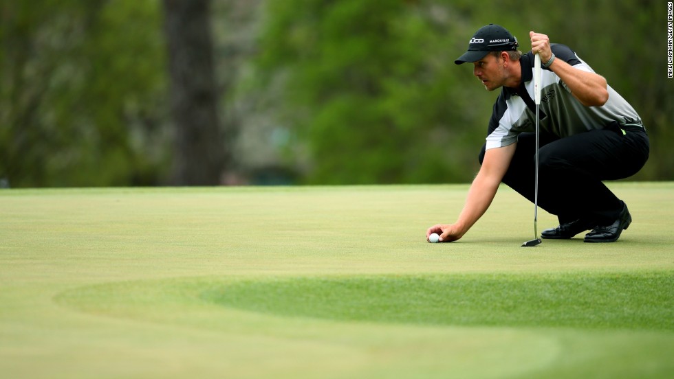 Henrik Stenson of Sweden lines up a putt on the third green during the final round.