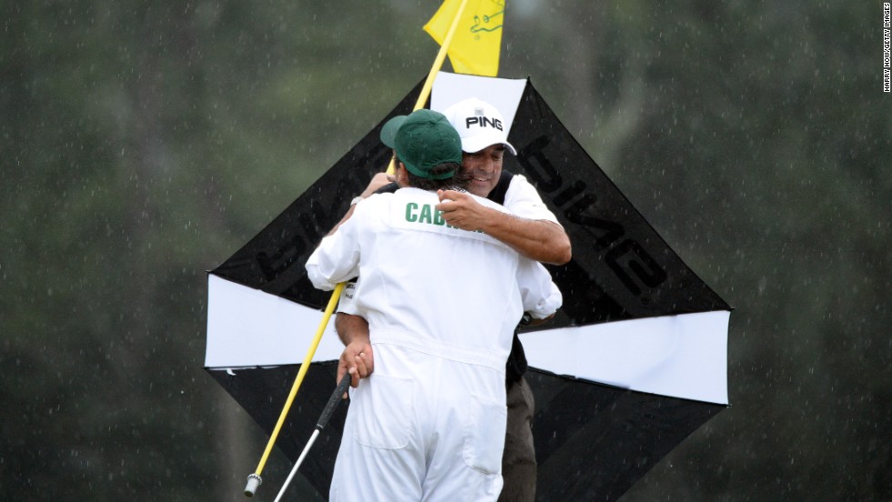 Angel Cabrera of Argentina hugs caddie Angel Cabrera Jr. after Cabrera makes a birdie putt on the 18th hole to force the playoff with Adam Scott of Australia.