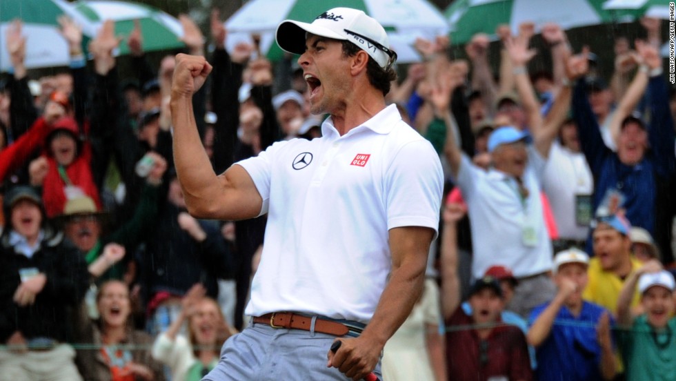 Adam Scott celebrates after he sinks a birdie putt on the 18th hole during regular play.