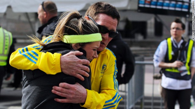 A woman is comforted by a man near a triage tent set up for the Boston Marathon after explosions went off at the 117th Boston Marathon in Boston, Massachusetts April 15, 2013.