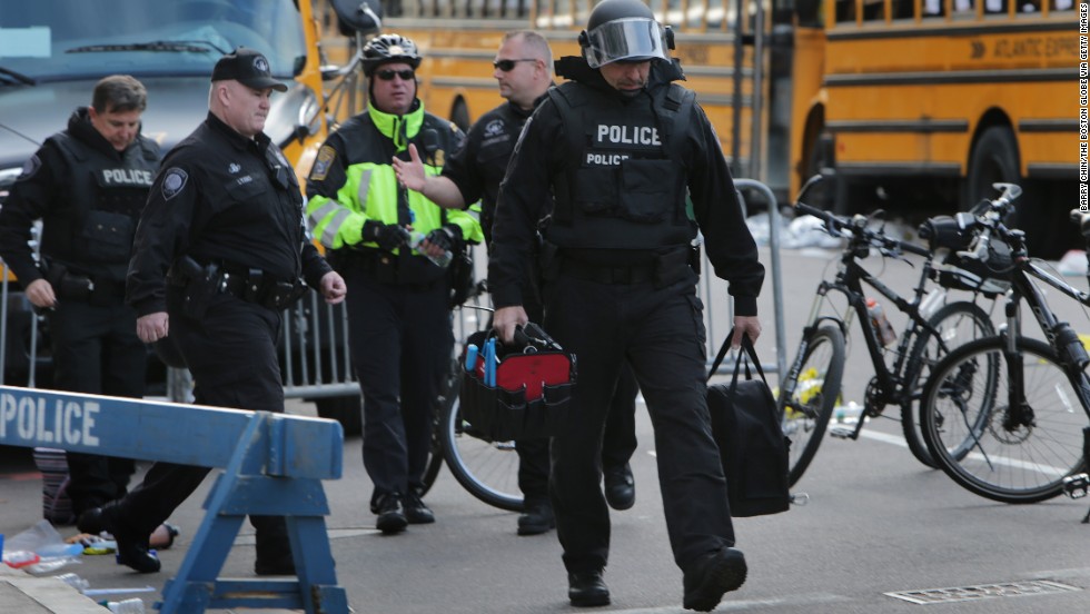 The Cambridge Police Department&#39;s bomb squad investigates unattended personal items left behind after the explosions.