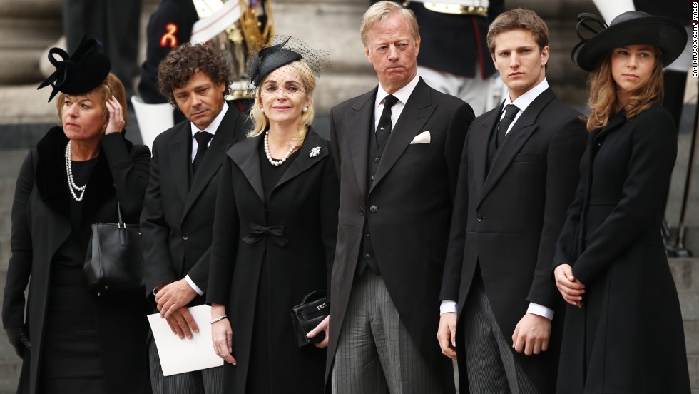 Carol Thatcher, Marco Grass, Sarah Thatcher, Mark Thatcher, Michael Thatcher and Amanda Thatcher watch from the steps of St. Paul&#39;s Cathedral as the coffin is placed in the hearse after the funeral.