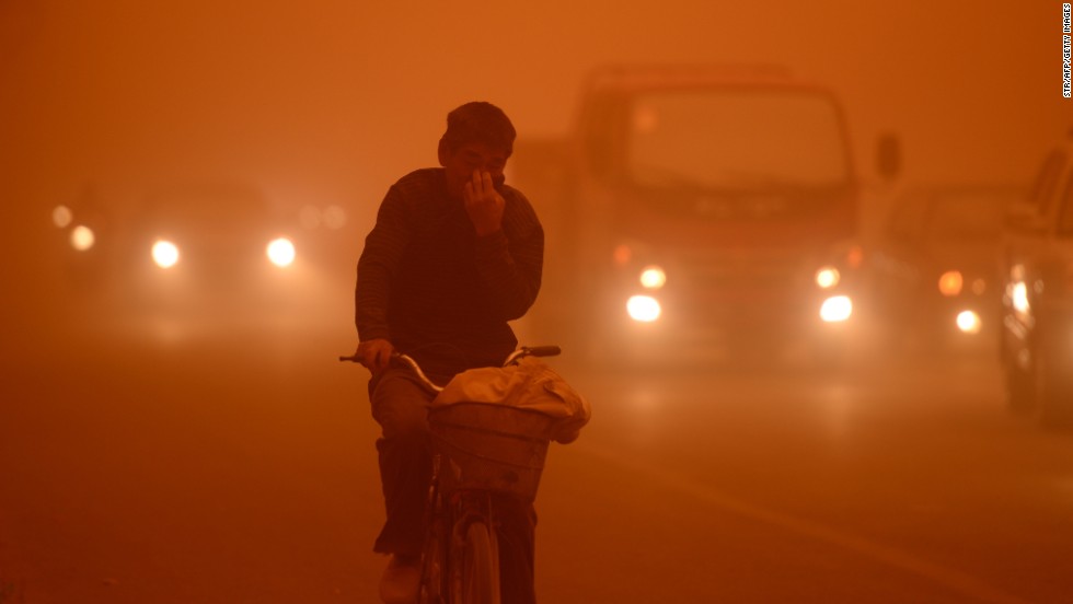 A man rides a bike during a heavy sandstorm in Yecheng county, northwest China&#39;s Xinjiang Uygur Autonomous Region, on Tuesday, April 16.