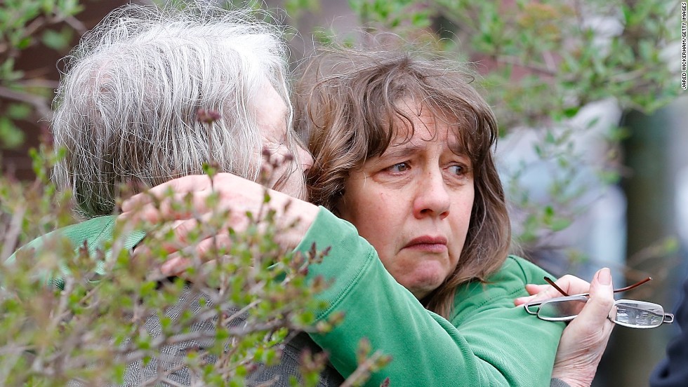 A woman is questioned by Cambridge police and other law enforcement agencies Friday near the home of the second suspect in Cambridge, Massachusetts. A Massachusetts Institute of Technology campus police officer was shot and killed late Thursday night at the school&#39;s campus in Cambridge. A short time later, police reported exchanging gunfire with alleged carjackers in nearby Watertown. 