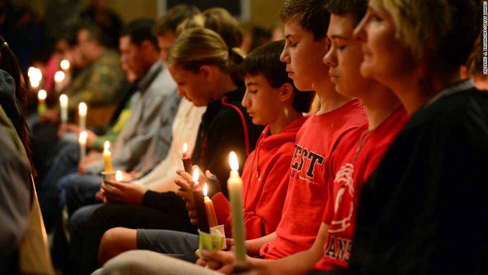 People gather for a candlelight vigil at a church in West on April 18.