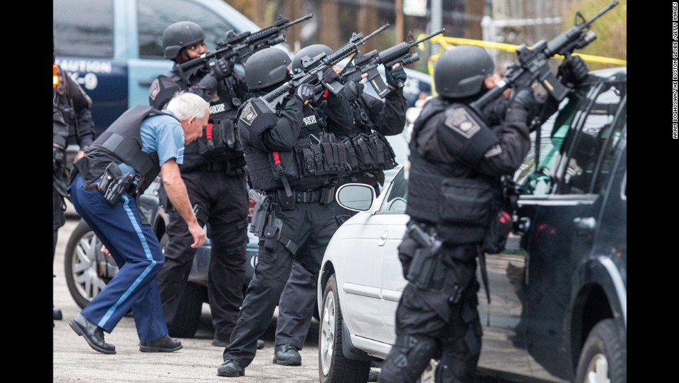 SWAT teams gather at the intersection of Nichols and Melendy avenues in Watertown while searching for the remaining suspect on Friday.