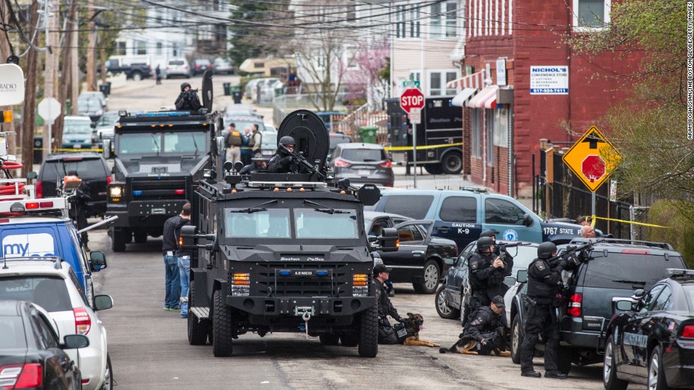 SWAT teams move into position at the intersection of Nichols and Melendy avenues in Watertown, Massachusetts, on Friday. 