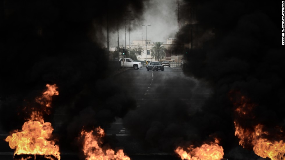 Tires placed on the road by anti-regime protestors burn during clashes with riot police in the village of Diraz, west of Manama. Bahrain riot police fired tear gas and stun grenades at protesters, who hurled petrol bombs during protests against the staging of the race. 