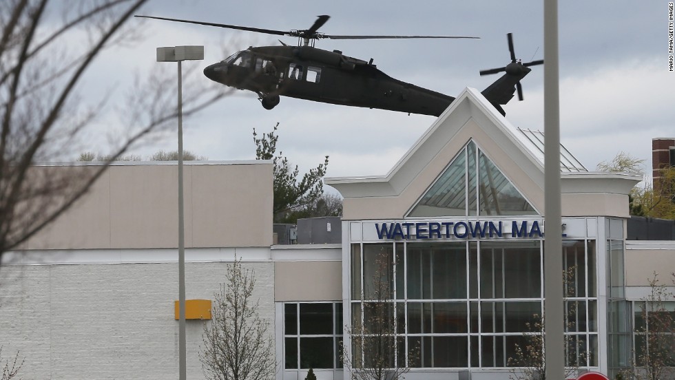 A U.S. military helicopter lands behind Watertown Mall as law enforcement agencies continue to search for the 19-year-old bombing suspect on Friday.