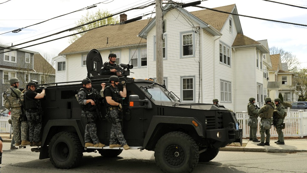 A police SWAT team searches houses on April 19 for the second suspect.