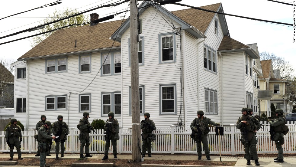 SWAT team members line a residential street in Watertown, Massachusetts, as the manhunt continues on Friday.