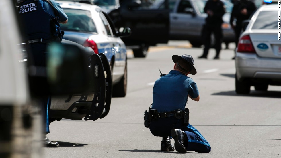 Law enforcement officers react to what was initially thought to be a threatening suspect on Arsenal Street on April 19.