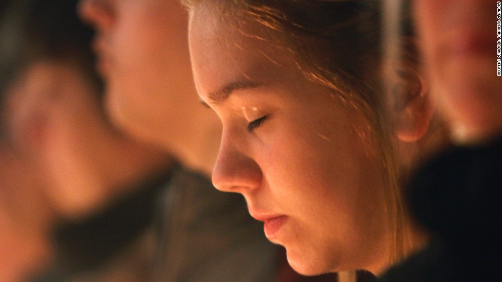 A girl closes her eyes during the vigil. 