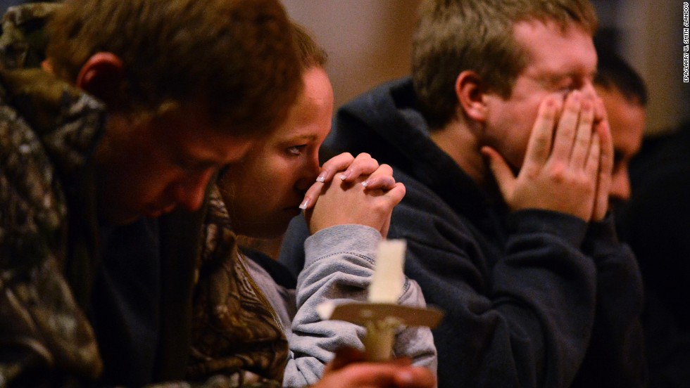 People pray during a candlelight vigil at St. Mary&#39;s Church on April 18.