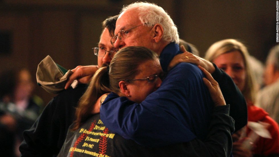 Residents embrace after taking part in the vigil.