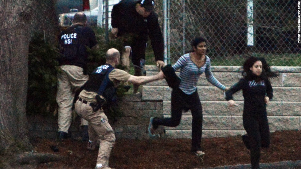 Residents flee from an area where a suspect was hiding on Franklin Street on April 19.