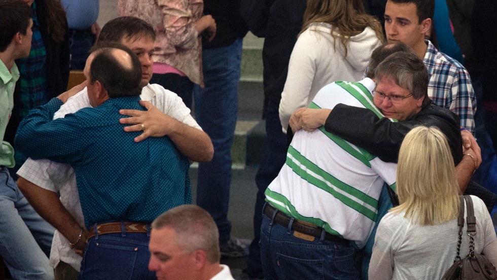 Residents embrace after a Sunday service at St. Mary&#39;s Catholic Church on April 21, four days after the deadly explosion.