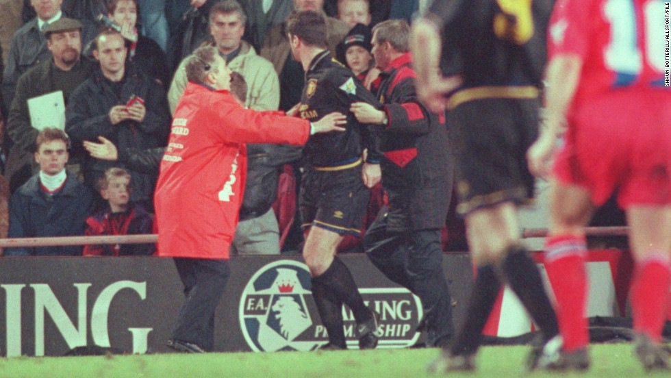 Manchester United&#39;s Eric Cantona suffered a moment of madness during an EPL match at Crystal Palace in January 1995.  Cantona had been given a red card for kicking an opponent and, while making his exit from the pitch, the Frenchman jumped over the advertising boards and aimed a scissor kick at a fan who he claimed was shouting insults at him. Cantona was banned for nine months and also served 120 hours community service.