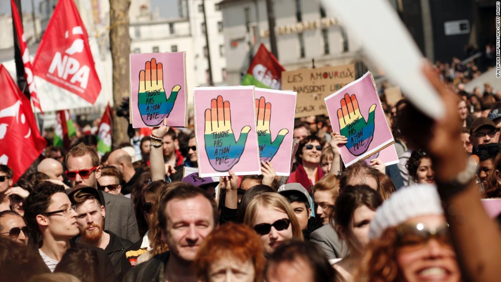 Gay marriage supporters raise signs in Bastille Square on Sunday.