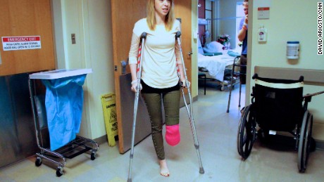 Adrianne Haslet-Davis, a dance instructor, walks in her hospital room at Boston Medical Center, April 22, 2013. She and her husband were among the more than 170 victims injured at the Boston Marathon last Monday. Surgeons were forced to amputate part of her leg, five inches below her left knee.