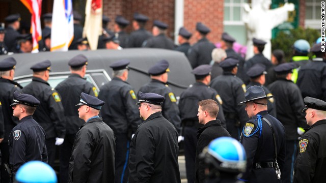 Image #: 22091533    epa03673984 Law enforcement officials enter St. Patrick's Church in formation prior to the funeral for Massachusetts Institute of Technology (MIT) Police Officer Sean Collier in Stoneham, Massachusetts, USA, 23 April 2013. Collier was allegedly shot and killed by Dzhokhar and Tamerlan Tsarnaev on 18 April 2013. Three victims were killed and over 200 were injured on 15 April 2013 in an apparent terrorist attack near the finish line of the 117th Boston Marathon that prompted a intense manhunt for 19 year-old Dzhokhar Tsarnaev who was found hiding in a boat in a backyard.  EPA/CJ GUNTHER /LANDOV